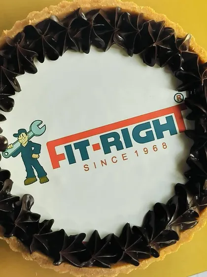 Another angle of the custom logo chocolate tart, showing the clean, crisp edible print surrounded by decadent chocolate piping. It's a professional and delicious way to represent your brand.