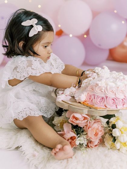 A beautiful at-home cake smash with a pink and white theme. I customize the setup to match your vision for your baby's special day.