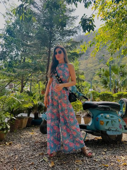 Posing with a cute scooter in Rishikesh. This floral jumpsuit is a fun and photogenic piece for any travel diary.