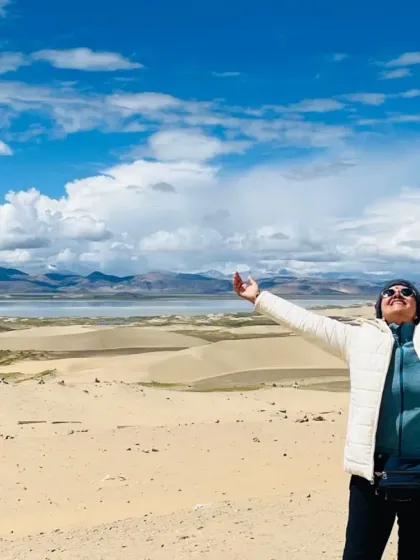 A fellow seeker with arms outstretched, embracing the vastness of the Tibetan plateau. It is a landscape that invites you to open up completely.