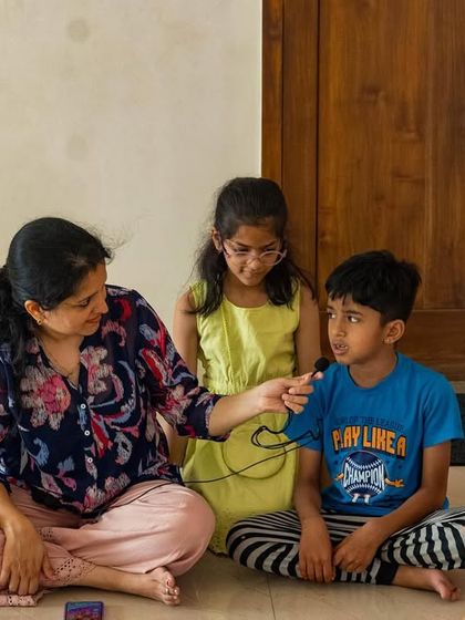 A teacher gently encourages a young boy to share his voice. My workshops are about creating a safe space where every child feels seen, heard, and confident enough to participate in their own way.