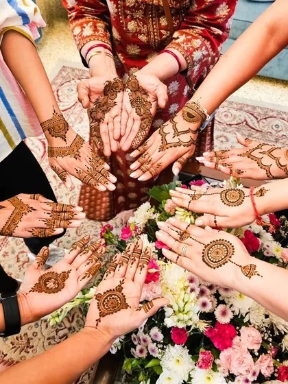 Mehendi is for everyone in the celebration. Here, the bride's tribe shows off their matching minimalist designs, creating a beautiful, unified look and a fun memory for the whole group.