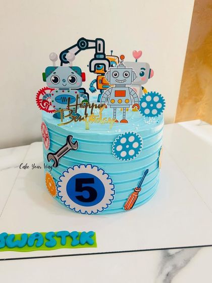 Gears, bots, and birthday fun. This robot-themed cake with its cool blue stripes and mechanical details is perfect for a future engineer's 5th birthday.
