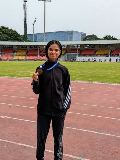 Posing with a bronze medal after a tough 80m hurdles race at the Maharashtra junior state meet in Pune.