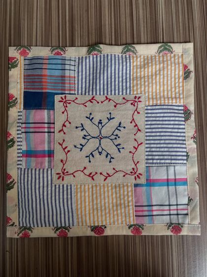 This envelope pouch is made from leftover fabric scraps, a small step towards sustainability. Of course, it had to have a touch of hand embroidery at its center.