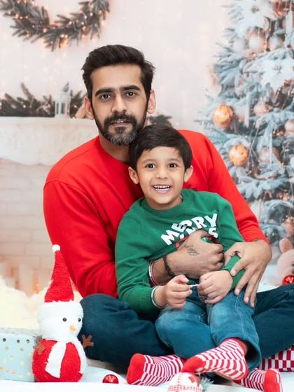 A father and son share a happy moment during their Christmas photoshoot. These sessions are a great way to create holiday memories.