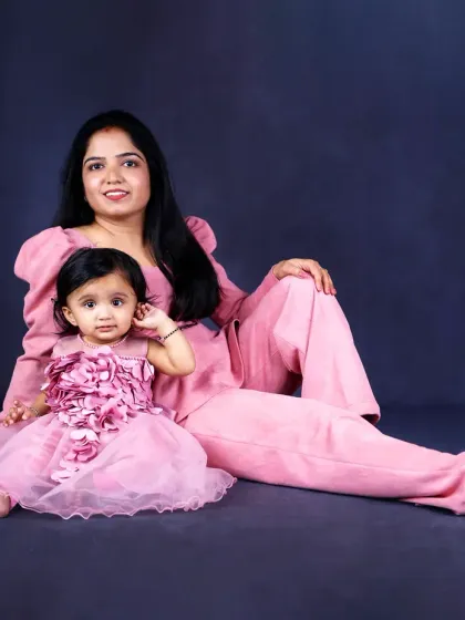 A mother and daughter in matching pink outfits. This fine-art portrait is a beautiful celebration of their special bond.