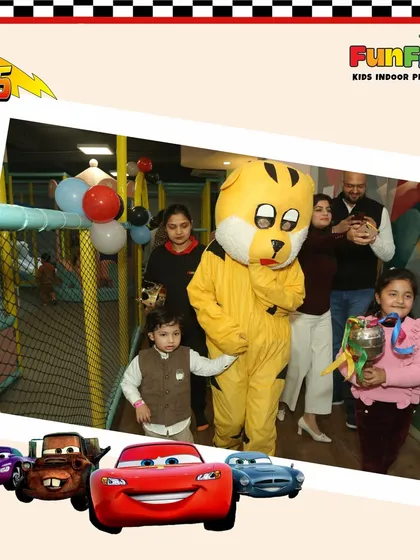 Our mascot loves to join in the birthday fun! Here's a happy family moment from a car-themed party.