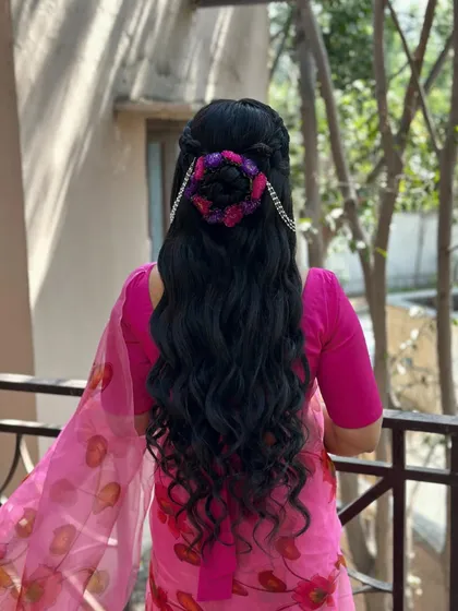 Another angle of the creative haldi hairstyle, showing the vibrant colors of the hair accessory.