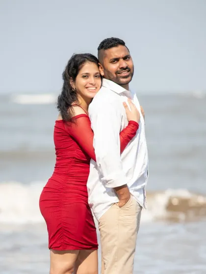 A happy, candid moment from a beach pre-wedding shoot. The way she leans into him with a smile shows their easy and comfortable connection.