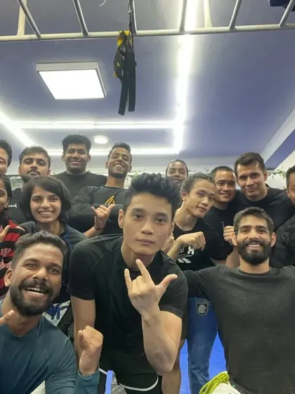 An energetic group photo after an intense No-Gi open mat session.