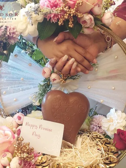We love creating unforgettable gifts for your special moments. This custom hamper was designed for a Promise Day celebration, featuring a large chocolate heart, assorted confections, and beautiful floral arrangements.