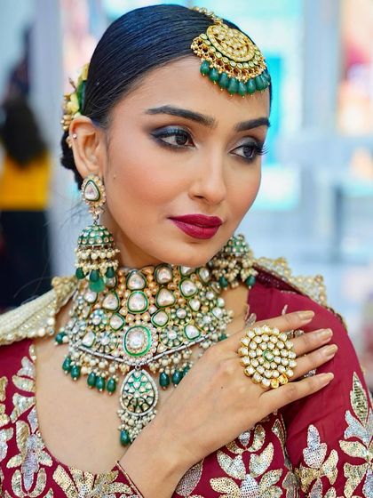 This portrait captures the regal essence of the bridal look, enhanced by the heavy green jewelry. You will learn to use color theory to complement colorful accessories.