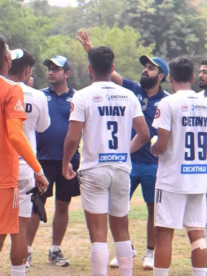 A huddle during a match where the coach provides tactical adjustments to the team, showcasing our dynamic approach to game management.