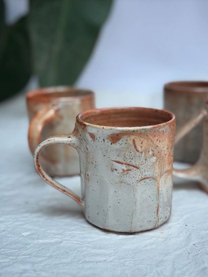 A group of our Shino coffee cups, ready to be sent to their new homes. The warm, toasty variations in the glaze are so inviting.