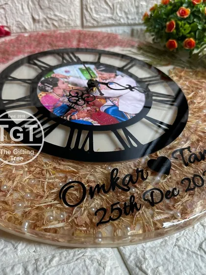 A close-up on the lower half of the 16-inch clock, showing the custom names and wedding date in a clean, black font.