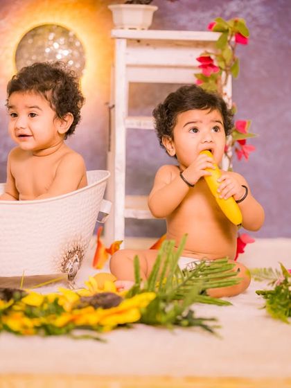A playful bath time scene for two. This setup includes a classic white tub and sunflower props, creating a bright and cheerful environment for capturing candid moments between twins.