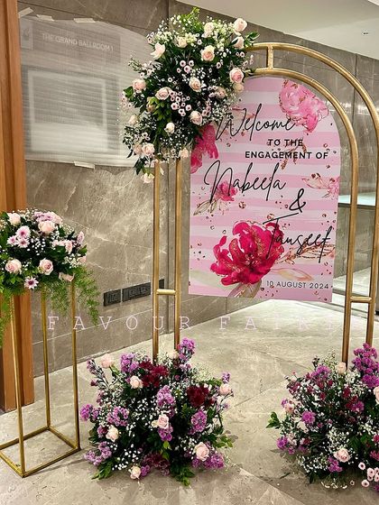 A chic welcome sign for Nabeela and Tauseef's engagement. We used a modern gold arch frame, a custom-designed sign, and beautiful floral arrangements to greet guests in style.