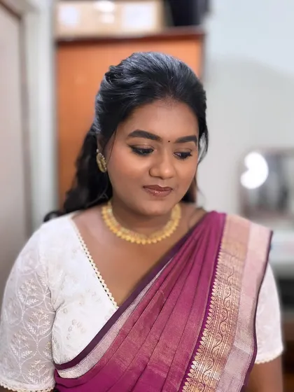 A final look at Subha's makeup. The skin is dewy, the eyes are softly defined, and the lips have a natural tint.