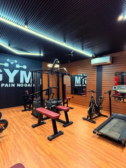 Another angle of the gym, showing the multi-gym station and cardio equipment. We installed an air conditioner to ensure the space is comfortable for workouts in any season. The mirrors are strategically placed to help with form and make the space feel larger.