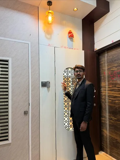 Standing at the entrance of a completed project. The design features a unique door with a jaali-work window, setting a tone of detailed craftsmanship from the moment you arrive.