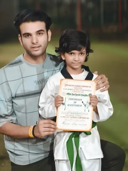 A proud moment with one of our green belt students, celebrating his achievement in a recent championship.