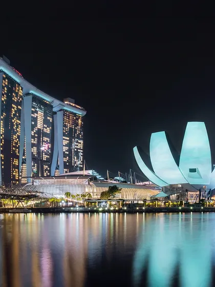 A closer shot of the Marina Bay Sands and ArtScience Museum, highlighting their unique architecture and night-time illumination.