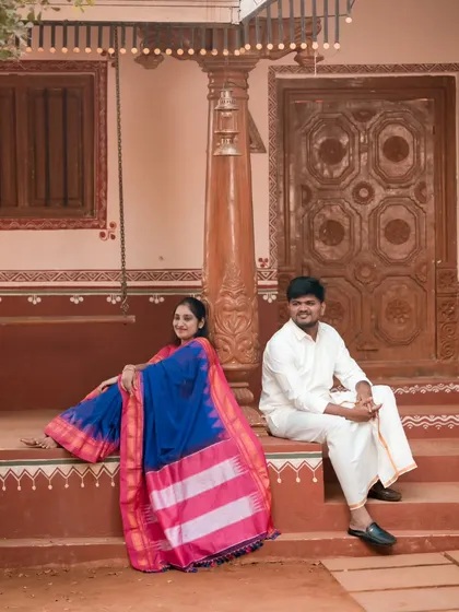 We love capturing timeless traditions. This couple is dressed in beautiful ethnic wear, posing at a rustic, traditional village-style location we arranged.