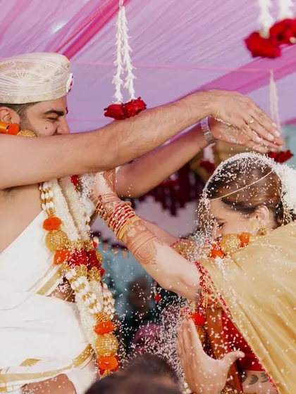 The Talambralu or Akshata ceremony is a beautiful, chaotic, and joyful part of many South Indian weddings. My goal is to freeze that peak moment of action and happiness, showing the couple's interaction amidst the shower of rice and petals.