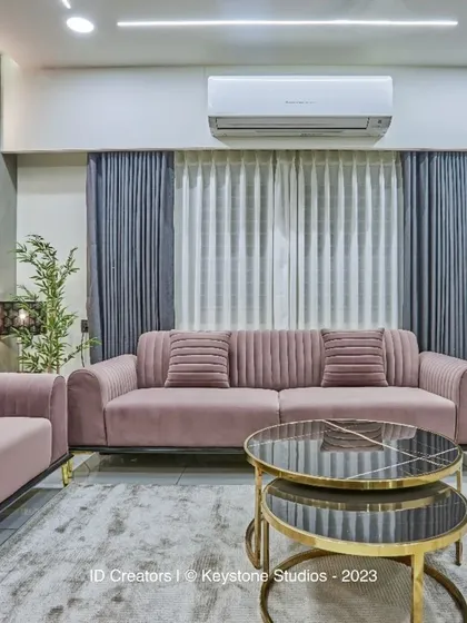 The living room is designed for comfort, with plush sofas, layered curtains, and a neutral color scheme that promotes relaxation.