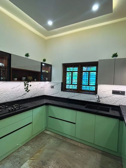 This kitchen concept uses a refreshing pastel green acrylic finish for the base cabinets, contrasted with grey upper cabinets and a 3D-patterned backsplash. The result is a bright and modern cooking space.