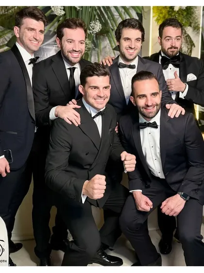 The boys are back in town! A dapper group of friends looking sharp and ready to celebrate at a cocktail event.