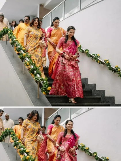The bride's procession for her Haldi ceremony, walking down the stairs with her family, all dressed in beautiful shades of yellow and pink.