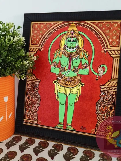 The completed Sankatamochana Hanuman, framed and placed in a home setting. The powerful green of Hanuman against the deep red background creates a striking visual that brings strength and devotion to the room.