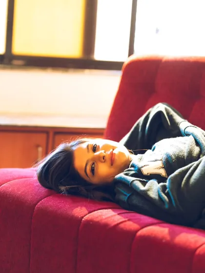 A candid, smiling moment that captures the relaxed and fun atmosphere of a shoot at home.
