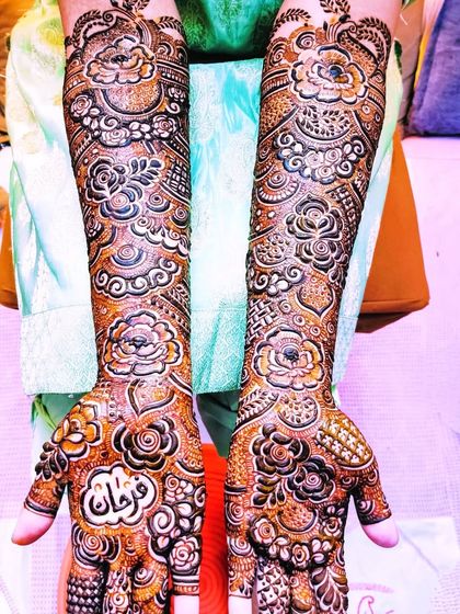 A full bridal look for Farheen, with matching intricate designs on her hands and feet.