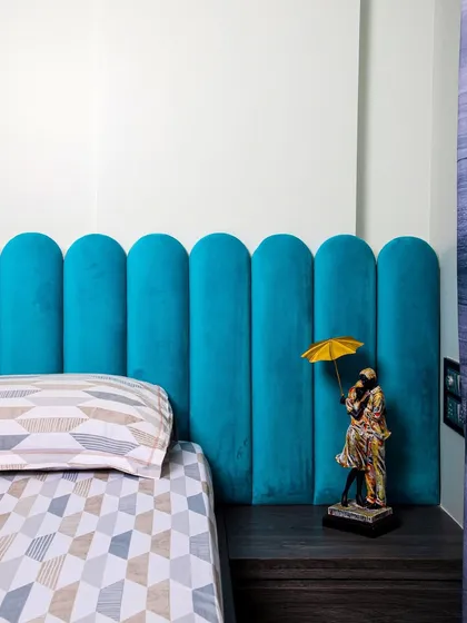 A close-up detail showing a small, charming figurine next to the unique headboard, adding a personal and whimsical touch.