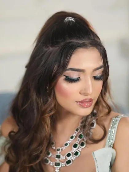 A detailed close-up of the eye makeup, showing the precision of the winged liner and the beautiful shimmer.