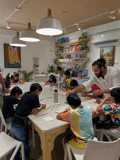An instructor helps a group of young boys with their drawing and painting during a fun-filled birthday workshop. We ensure every child gets the attention they need.