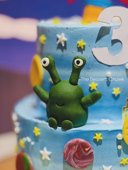 Another one of the little green aliens from the space cake, adding a playful touch to the design.