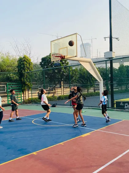A young female player takes a shot, showing the confidence we build in all our athletes.