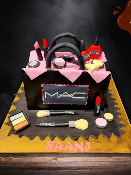 For the ultimate makeup lover, I sculpted this MAC-themed cake shaped like a makeup bag overflowing with edible lipsticks, brushes, and palettes. Every detail is handcrafted from fondant for a glamorous and delicious surprise.