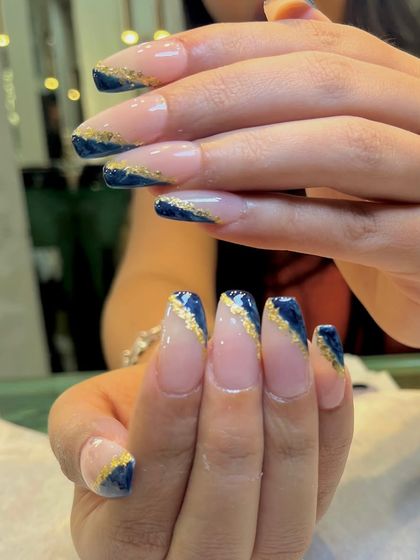 Another angle of the midnight blue and gold foil nails, showing how the gold catches the light.