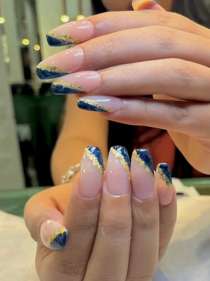 Another angle of the midnight blue and gold foil nails, showing how the gold catches the light.
