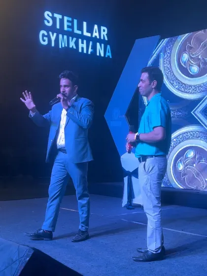 Explaining the next phase of a mentalism trick on stage. Clear communication in both English and Hindi ensures everyone is part of the experience.