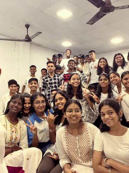 A cheerful group selfie with students dressed in white, marking the beginning of our nine-day Navratri celebration.