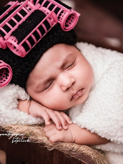 A close-up of our little spa client, looking perfectly content with her hair rollers and fluffy robe.