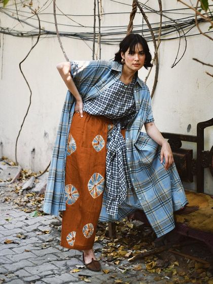 A dynamic pose that showcases the art of layering different prints and fabrics. This image is a celebration of pattern-mixing and individual style.