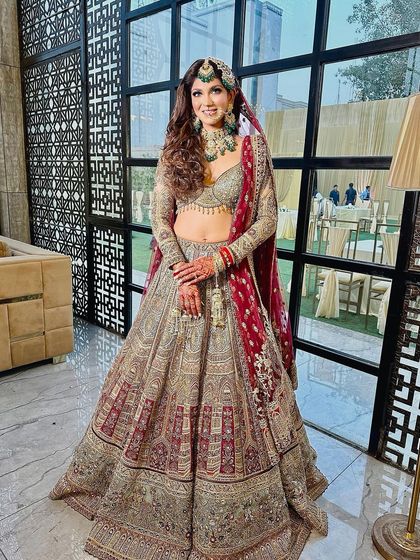 A full-length indoor shot showing how the makeup looks just as stunning under artificial lighting. She truly looks like a queen.