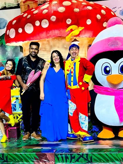 A colorful group photo featuring our Penguin mascot, a dwarf character, and a juggling clown posing with happy clients. We provide a variety hub of performers to enhance any day.